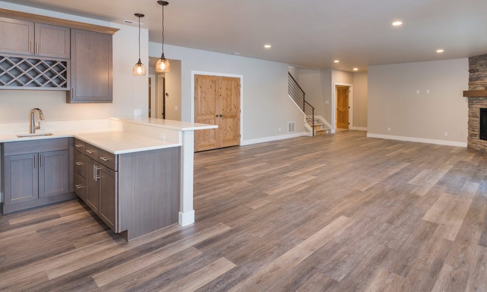 basement room with built-in wet bar, fireplace and hardwood floor