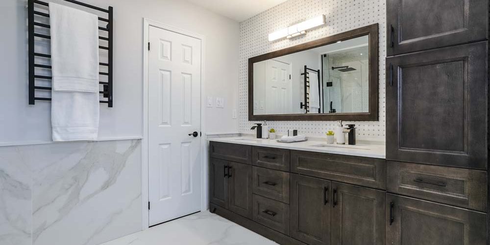 double vanity with hardwood cabinets, wall clothes racks, luxury tiles and white door