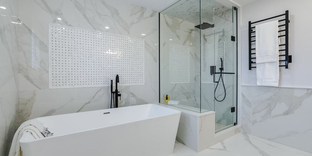 dominant white color of the newly renovated bathroom with a bathtub that adds a touch of sophistication to the space