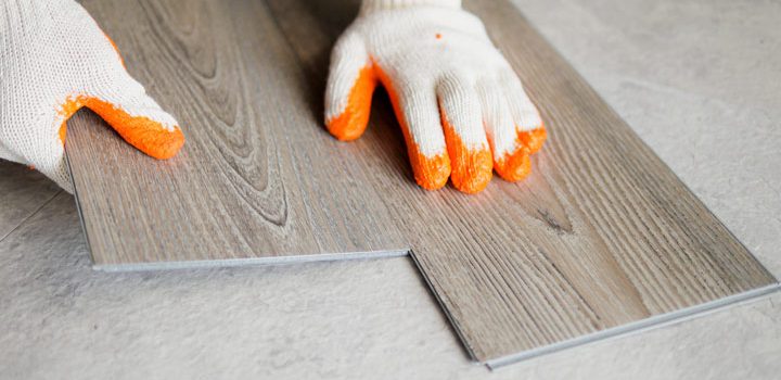 man working on installing a laminate flooring in the home